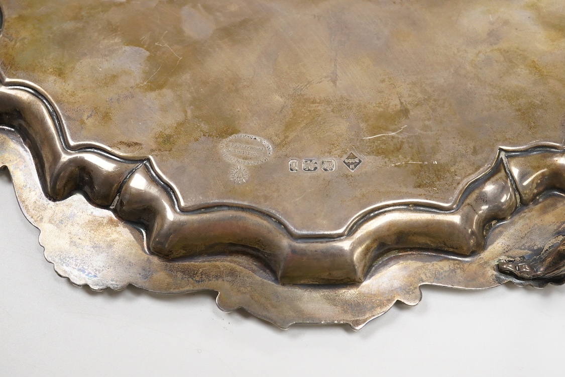 A late Victorian silver salver, with shell and scroll border and engraved inscription, on three claw and ball feet, Mappin Brothers, Sheffield, 1896, 26.4cm, 15.2oz.